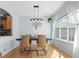Bright dining room with modern light fixture and large window at 3425 W 111Th Loop # B, Westminster, CO 80031