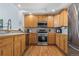 Well-lit kitchen with wood cabinets and stainless steel appliances at 3425 W 111Th Loop # B, Westminster, CO 80031