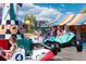 A fun-filled amusement ride with colorful cars and happy children enjoying the event at 7883 W 55Th Ave, Arvada, CO 80002