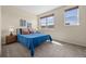 Inviting bedroom with cozy carpet, two bright windows, and warm decor at 7883 W 55Th Ave, Arvada, CO 80002