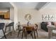 Cozy dining area adjacent to living room with seating for four, perfect for intimate meals at 7883 W 55Th Ave, Arvada, CO 80002