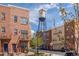 Brick townhomes with view of iconic Olde Town Arvada water tower on a sunny day at 7883 W 55Th Ave, Arvada, CO 80002