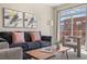 Comfortable living room with modern furniture, stylish decor, and sliding glass doors to balcony at 7883 W 55Th Ave, Arvada, CO 80002