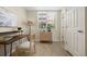 Bright home office featuring tile floors, a modern desk, and natural light from the window at 7883 W 55Th Ave, Arvada, CO 80002