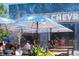 Outdoor patio seating at Denver Beer Co. under shade, with a lively, sunny ambiance at 7883 W 55Th Ave, Arvada, CO 80002