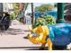 Street view with a blue and yellow pig statue, shops, and flowers at 7883 W 55Th Ave, Arvada, CO 80002