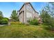 View of the home's backyard and landscaping at 10305 Charissglen Cir, Highlands Ranch, CO 80126