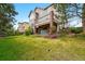 Expansive backyard featuring a lush lawn and a partially covered patio with a hot tub at 10305 Charissglen Cir, Highlands Ranch, CO 80126