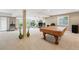 Spacious basement with pool table, bar area, and abundant natural light at 10305 Charissglen Cir, Highlands Ranch, CO 80126