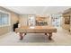 Basement featuring pool table, bar area with seating, and neutral carpeting at 10305 Charissglen Cir, Highlands Ranch, CO 80126