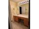 Bathroom boasting a double sink vanity, lots of storage, and large mirror at 10305 Charissglen Cir, Highlands Ranch, CO 80126