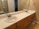 Well-lit bathroom featuring double sinks, ample counter space and a large mirror at 10305 Charissglen Cir, Highlands Ranch, CO 80126