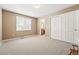 Neutral bedroom featuring large windows, closet, and views to the ensuite bathroom at 10305 Charissglen Cir, Highlands Ranch, CO 80126