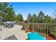 Expansive outdoor deck with seating, mature trees, and sunny lounge area at 10305 Charissglen Cir, Highlands Ranch, CO 80126