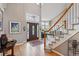 Elegant foyer featuring a high ceiling, a dark wood front door with sidelights, and a view of the staircase at 10305 Charissglen Cir, Highlands Ranch, CO 80126