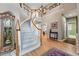 Grand foyer with a winding staircase, hardwood floors, and a view into adjacent living spaces at 10305 Charissglen Cir, Highlands Ranch, CO 80126