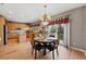 Bright eat-in kitchen with wood cabinets, a granite island, and sliding doors to the outdoor deck at 10305 Charissglen Cir, Highlands Ranch, CO 80126