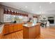 Bright kitchen with granite countertops, wooden cabinetry, and hardwood flooring, seamlessly flowing into the dining area at 10305 Charissglen Cir, Highlands Ranch, CO 80126