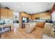Spacious kitchen featuring granite countertops, an island, and wood cabinets, with an adjacent desk area at 10305 Charissglen Cir, Highlands Ranch, CO 80126