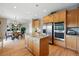 Bright kitchen with granite counters, stainless steel appliances, an island, and a connected breakfast nook at 10305 Charissglen Cir, Highlands Ranch, CO 80126