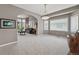 Large, open living area with ample natural light, featuring an archway and neutral wall colors at 10305 Charissglen Cir, Highlands Ranch, CO 80126