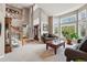 Bright living room featuring a high ceiling, large windows, and comfortable seating at 10305 Charissglen Cir, Highlands Ranch, CO 80126