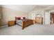 Neutral, carpeted, main bedroom featuring wooden furniture and ensuite bathroom at 10305 Charissglen Cir, Highlands Ranch, CO 80126