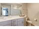 Bright bathroom with a vanity, a mirror, drawers, a shower curtain and a toilet at 5154 Bittercress Rd, Brighton, CO 80640