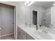 Double sink bathroom with a sleek vanity and a glass-enclosed shower at 5154 Bittercress Rd, Brighton, CO 80640