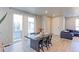 A dining area showcases a modern table, chairs, and sliding glass doors, creating an inviting space at 5154 Bittercress Rd, Brighton, CO 80640