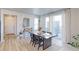 Dining area featuring a modern table and chairs, complemented by sliding glass doors for outdoor access at 5154 Bittercress Rd, Brighton, CO 80640