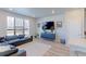 The well-lit living room boasts a large window and a stylish console table, offering comfortable living at 5154 Bittercress Rd, Brighton, CO 80640