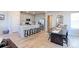 Open floor plan with dining area, island with seating and living room is an inviting, flexible space at 5154 Bittercress Rd, Brighton, CO 80640