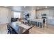 Open floor plan features a dining area, living room, and kitchen area with a view of the entire space at 5154 Bittercress Rd, Brighton, CO 80640
