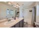 Bright bathroom showcasing double sinks, a large mirror, and a shower-tub combination at 1133 S Richfield St, Aurora, CO 80017