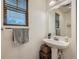 Cozy bathroom featuring a pedestal sink, wooden blinds, and decorative accents at 1133 S Richfield St, Aurora, CO 80017