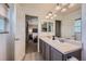 Bathroom featuring double sinks, tile flooring, and a view into the adjacent bedroom at 1133 S Richfield St, Aurora, CO 80017