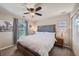 Comfortable bedroom features a king bed, ceiling fan, and large windows for ample natural light at 1133 S Richfield St, Aurora, CO 80017
