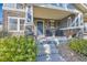 Charming covered porch with stone accents, seating, and landscaped entry to home at 1133 S Richfield St, Aurora, CO 80017