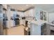 Modern kitchen with white cabinets, stainless steel appliances, and breakfast bar at 1133 S Richfield St, Aurora, CO 80017