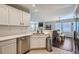 Open kitchen with stainless steel appliances, tile floors, and views to the dining and living areas at 1133 S Richfield St, Aurora, CO 80017