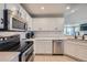 Updated kitchen with white cabinetry, stainless steel appliances, and bright lighting at 1133 S Richfield St, Aurora, CO 80017