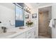 Modern bathroom featuring double sinks with stone countertops and a glass enclosed walk-in shower at 2801 Cherry St, Denver, CO 80207