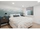 Calm bedroom featuring a gray accent wall and natural light at 2801 Cherry St, Denver, CO 80207