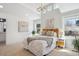 A bright bedroom with vaulted ceilings, a statement light fixture, and large windows with natural light at 2801 Cherry St, Denver, CO 80207