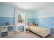 Bright ' bedroom with light blue walls and view to the yard at 2801 Cherry St, Denver, CO 80207