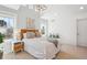A bright bedroom with vaulted ceilings, a statement light fixture, and large windows with natural light at 2801 Cherry St, Denver, CO 80207