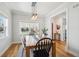 Bright dining room with modern light fixture, hardwood floors, and large window with neighborhood view at 2801 Cherry St, Denver, CO 80207