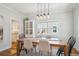 Open dining room with modern light fixture and view to the butler's pantry at 2801 Cherry St, Denver, CO 80207