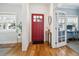 Bright foyer with red front door, light hardwood floors, and an adjacent office at 2801 Cherry St, Denver, CO 80207